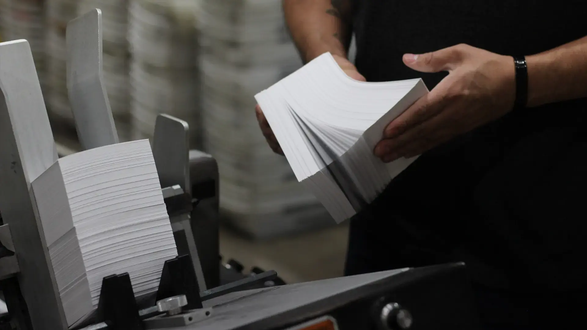 A person leafing through mailers