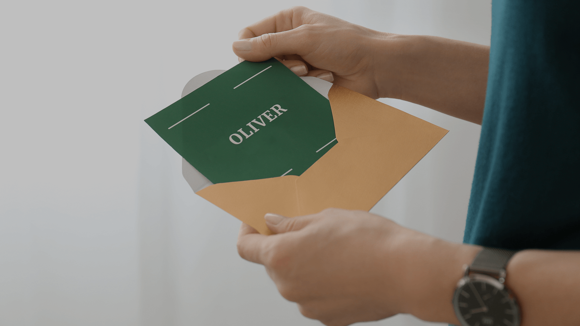 A person opening up a personalized invitation