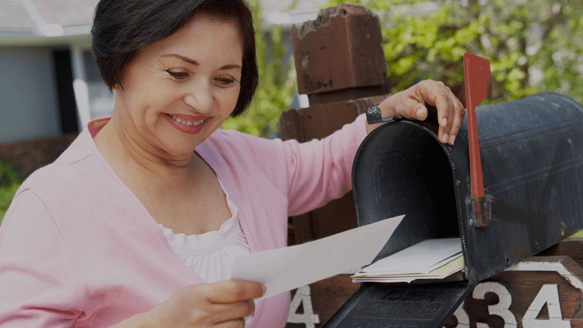 Women getting mail from mailbox